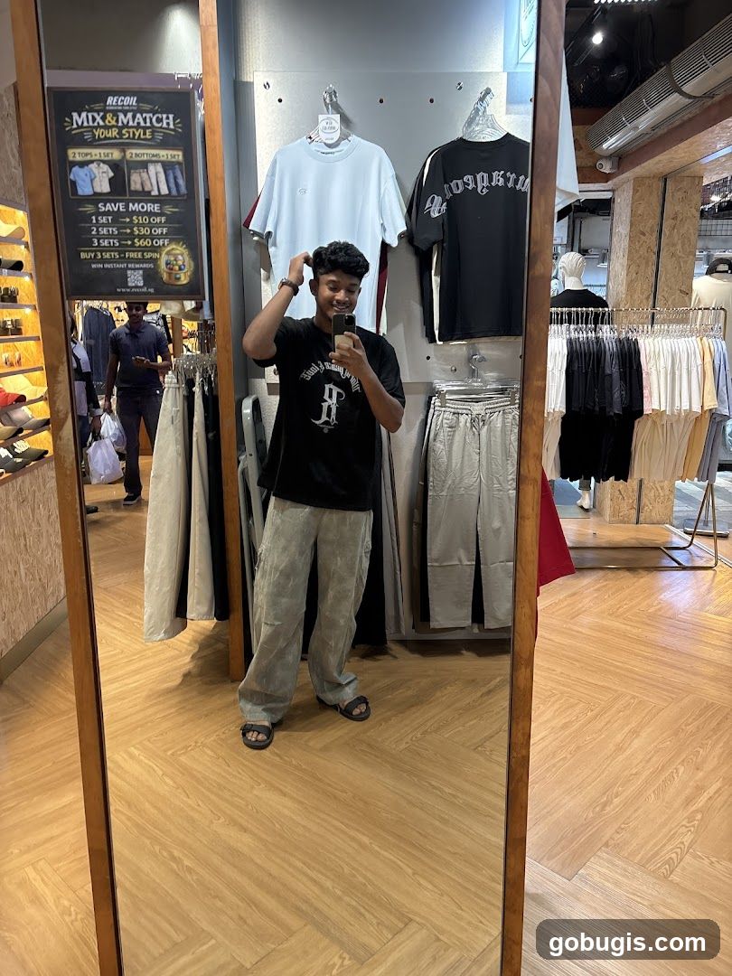 Man taking a mirror selfie in a clothing store