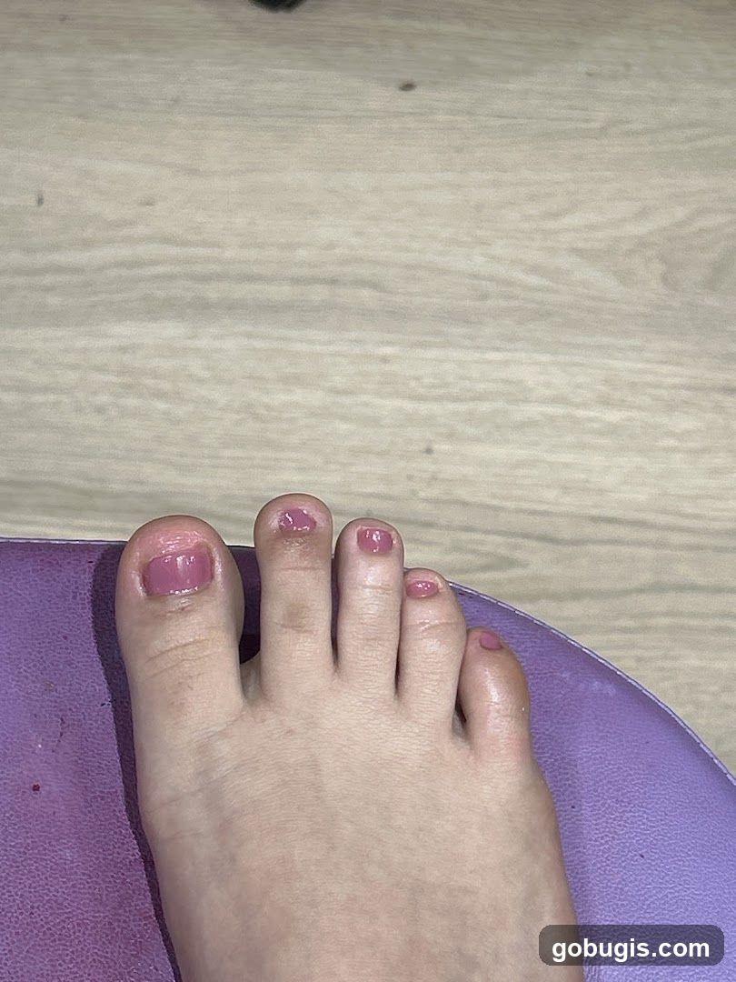 Close-up of a foot with pink nail polish