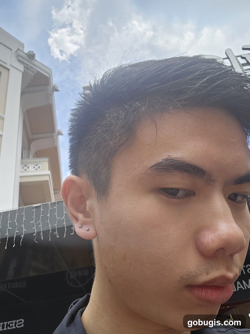 Man with multiple ear piercings
