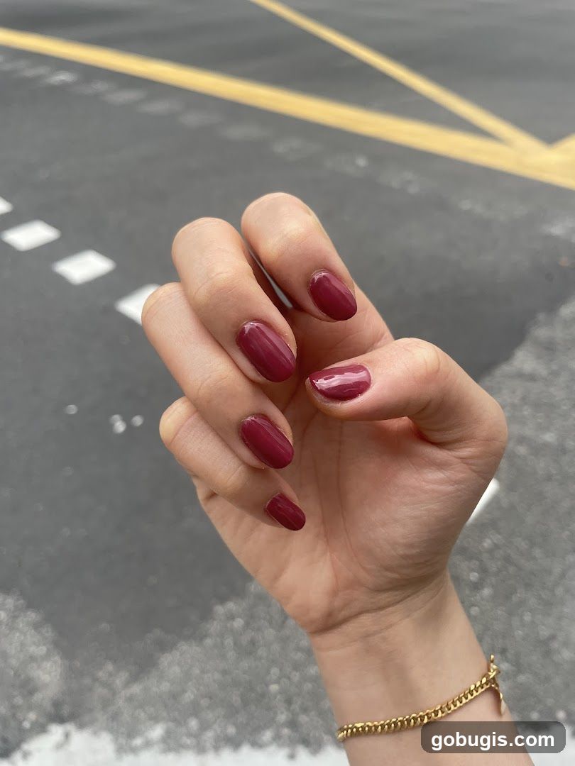 Woman's Hand with Burgundy Nail Polish