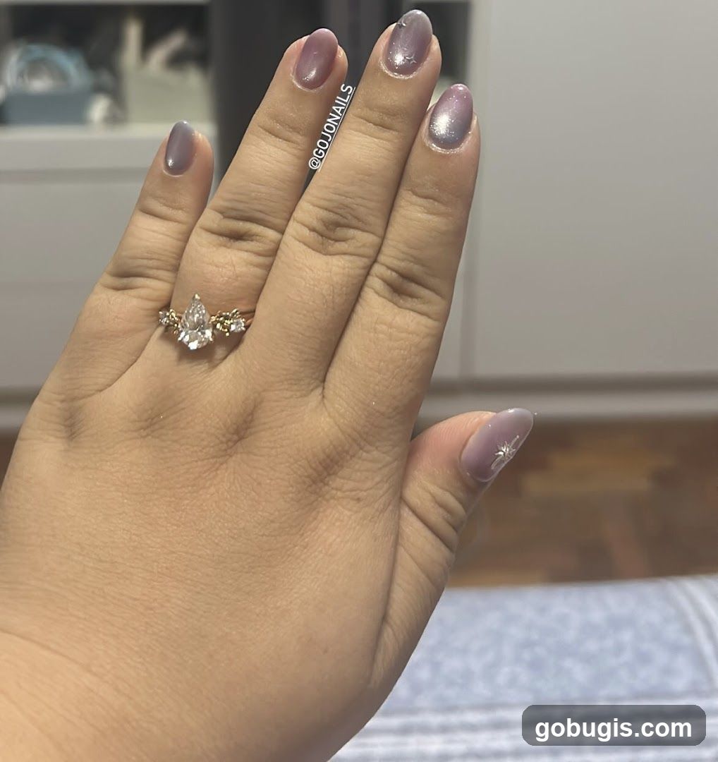 Hand with Ring and Decorated Nails