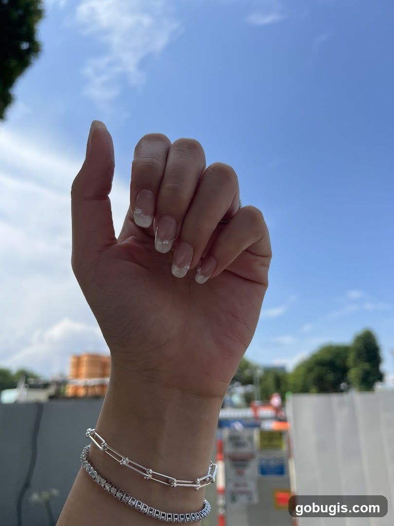 Hand with French Manicure and Bracelets