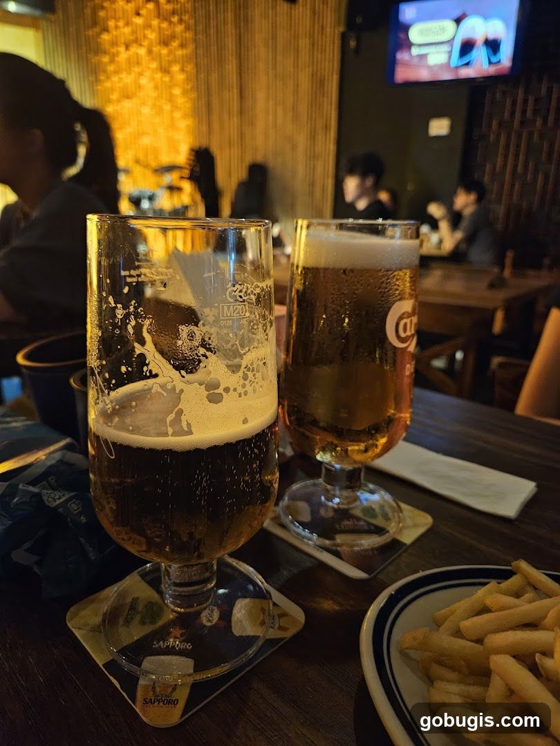 Two glasses of beer and fries on a table