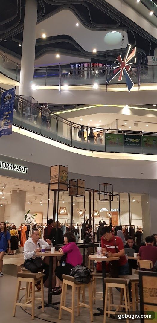 Indoor shopping mall with people dining and shopping