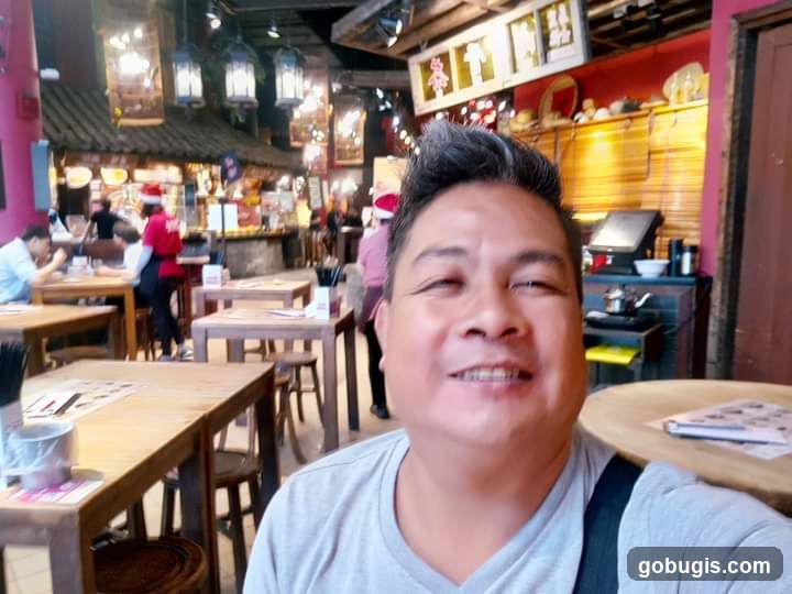 Man taking a selfie in a restaurant