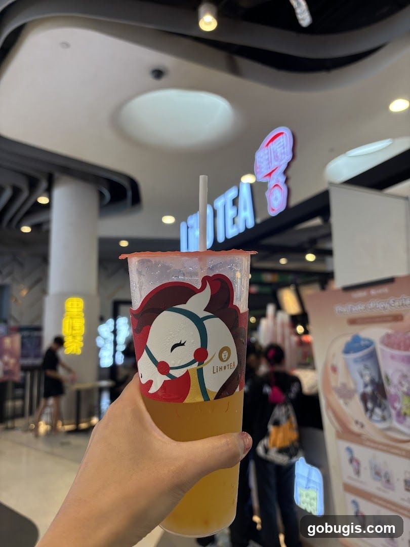 Hand holding a drink with a logo
