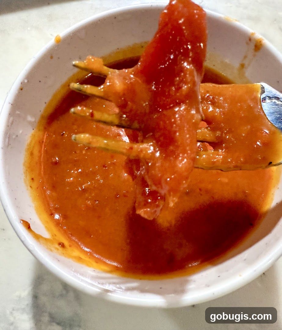 Food on Fork Dipped in Sauce
