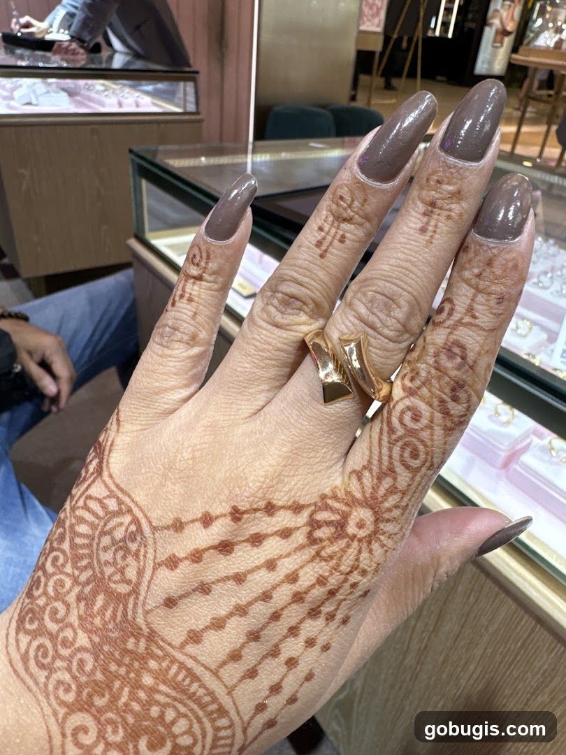 Woman's hand with henna and ring in jewelry store