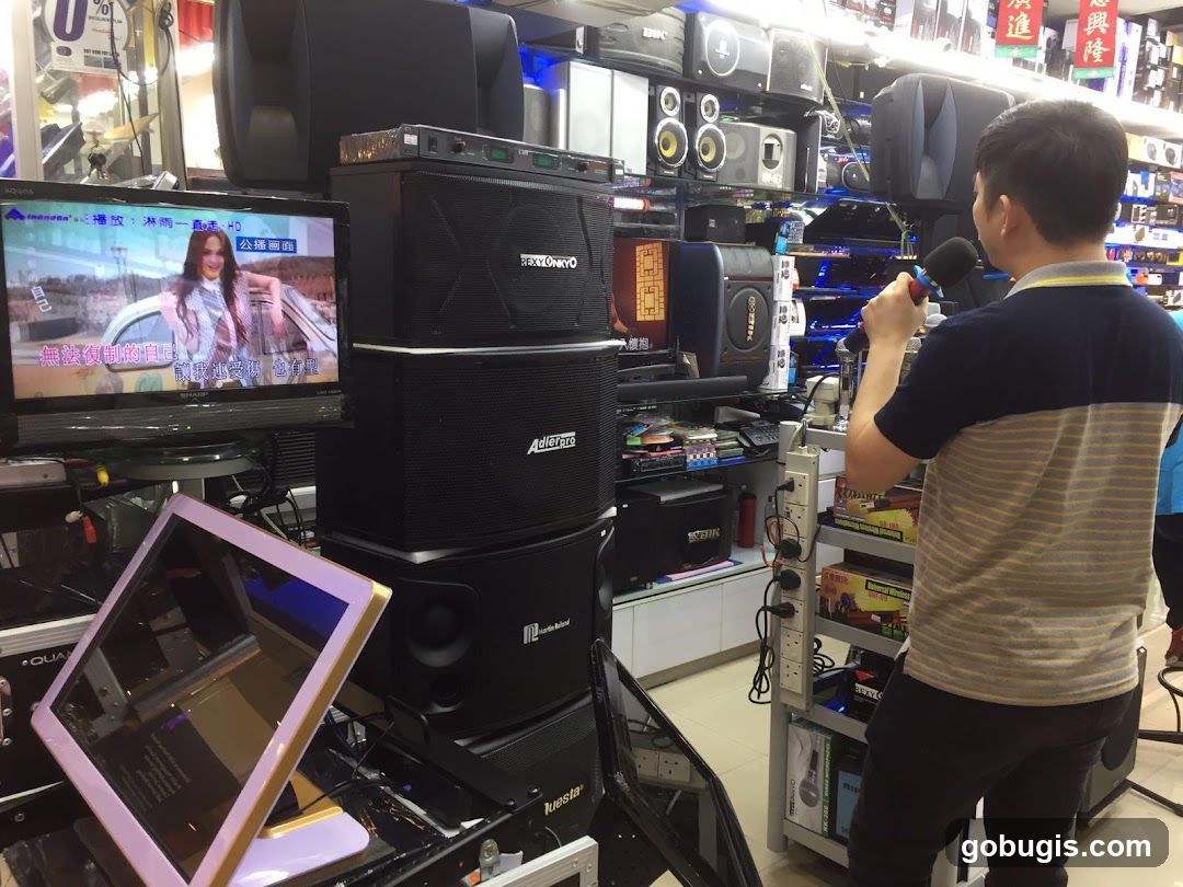 Man holding a microphone in an electronics store