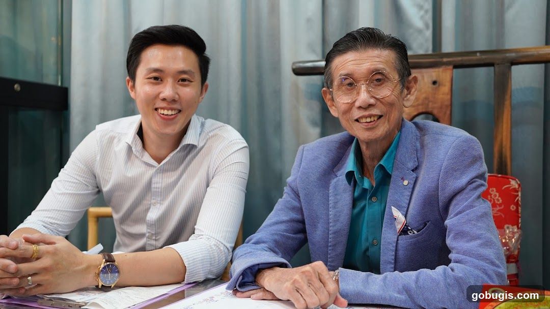 Two men smiling at a table