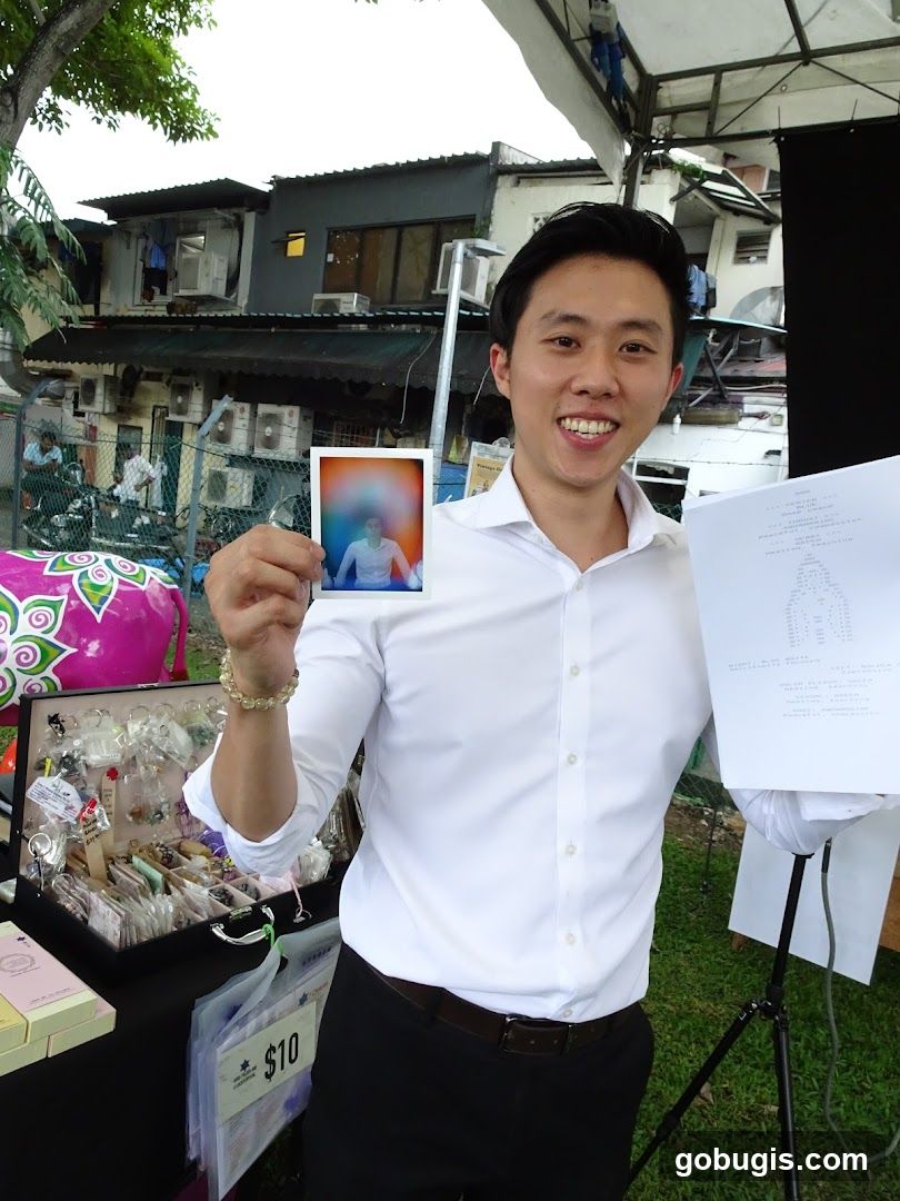 Man holding a polaroid and a document