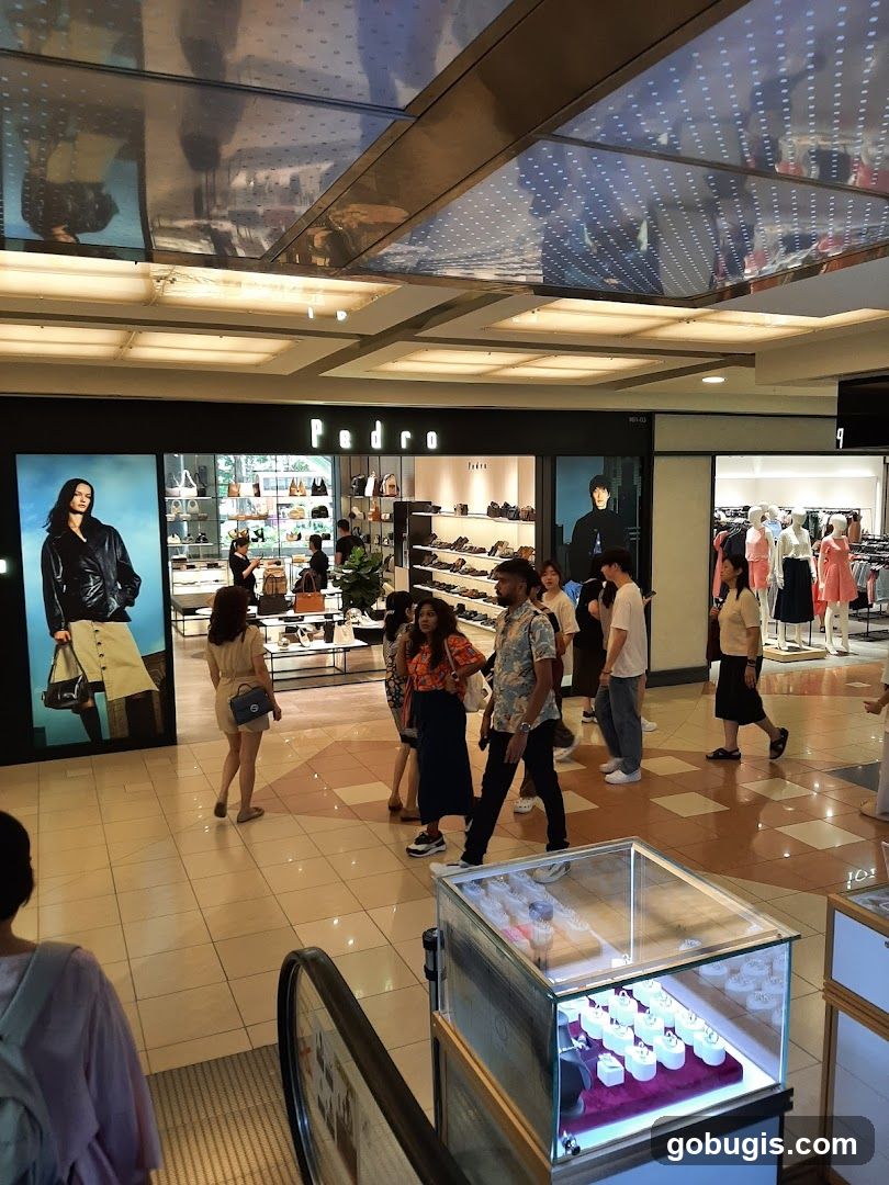 Shoppers in a mall in front of a Pedro store