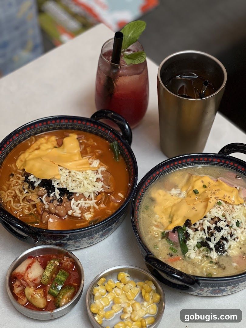 Two bowls of ramen with cheese and side dishes