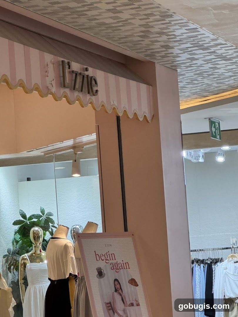 Storefront with mannequins and promotional sign