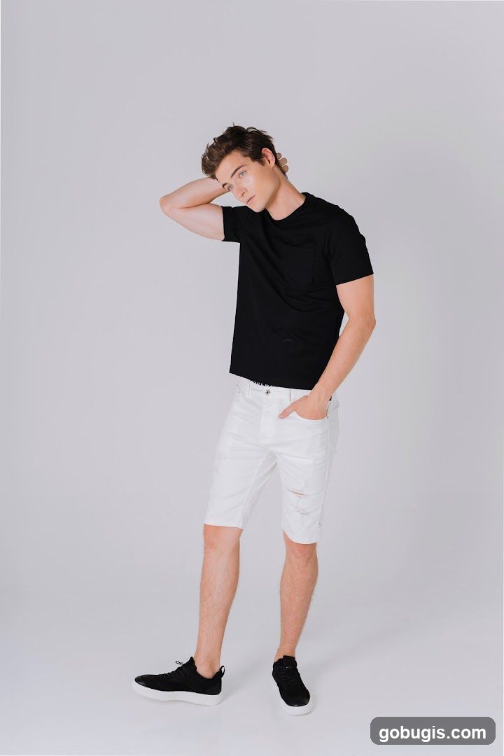 Man in Black T-shirt and White Ripped Shorts