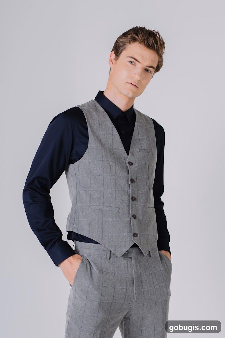 Man in a Grey Plaid Vest and Navy Shirt
