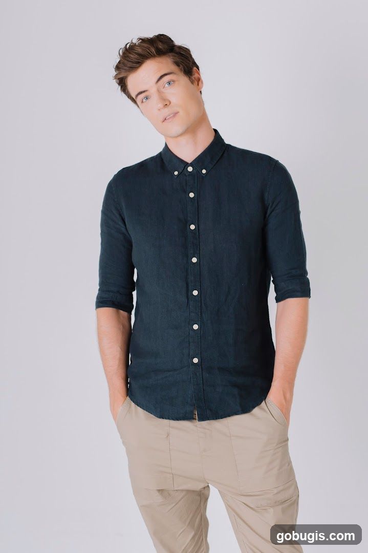 Man in a dark blue shirt and tan pants