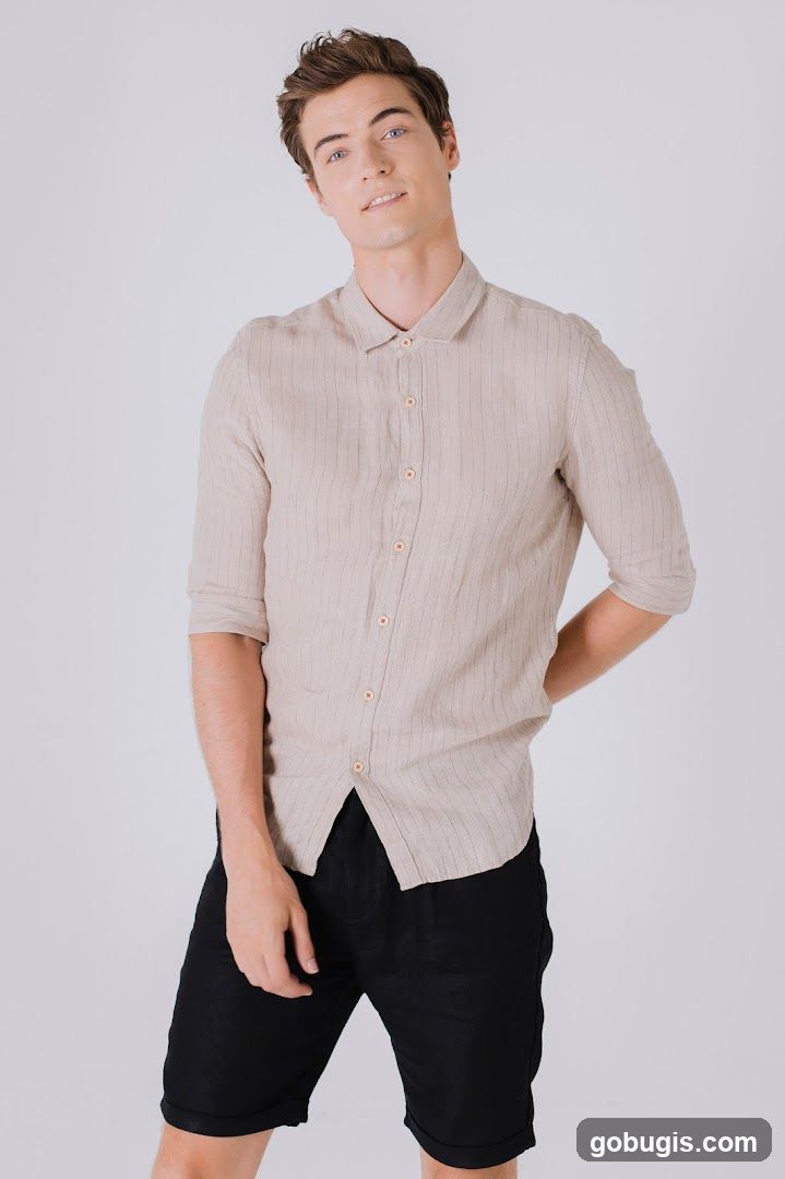 Man in Striped Shirt and Black Shorts