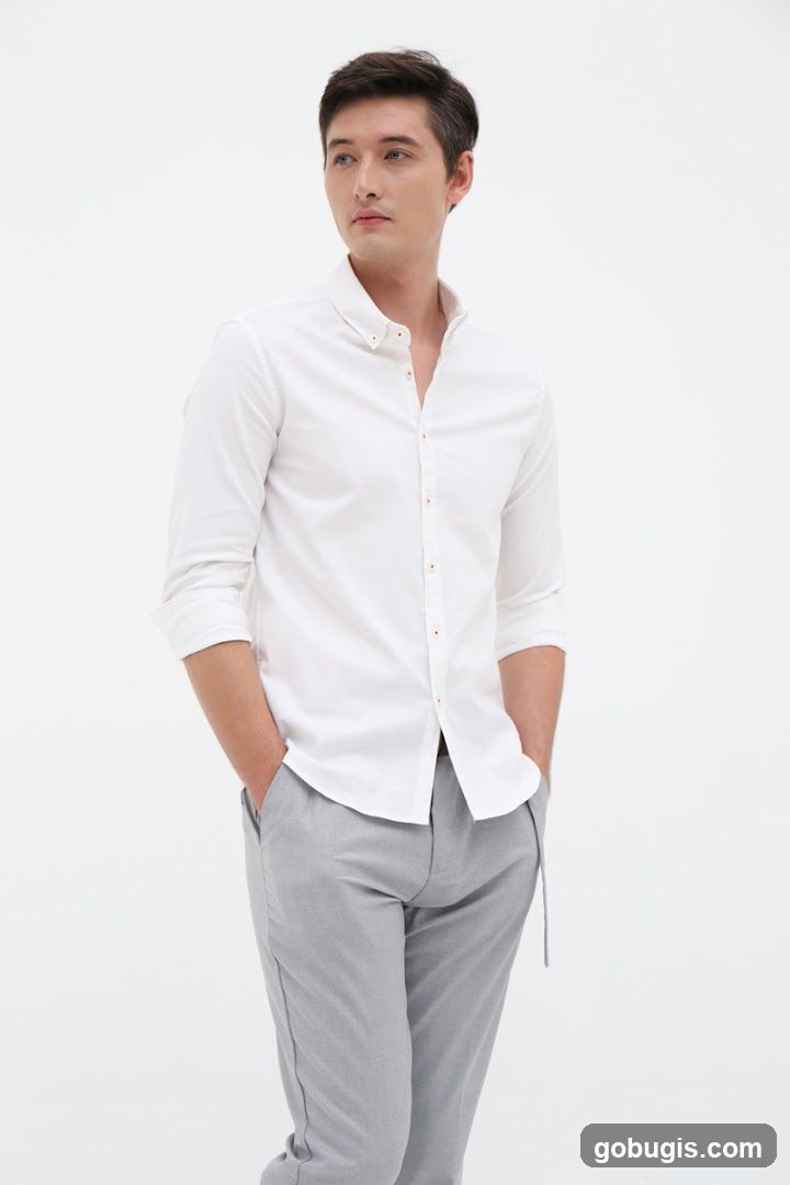 Man in White Shirt and Grey Pants