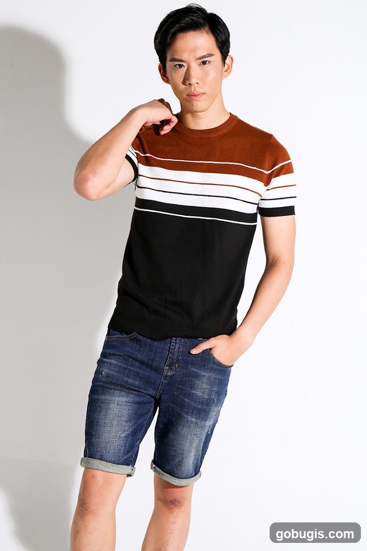 Man in Striped Shirt and Denim Shorts