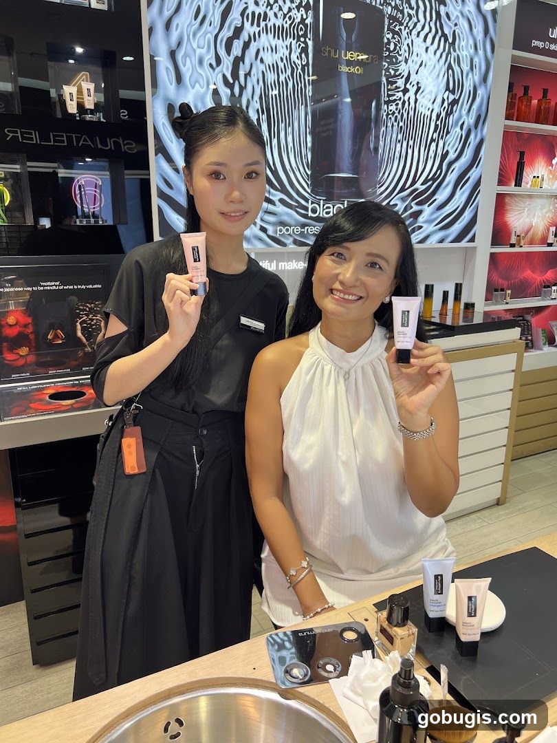 Two women holding cosmetic products