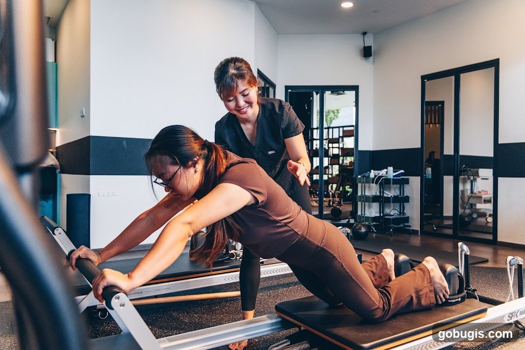 Pilates Instructor Assisting Client