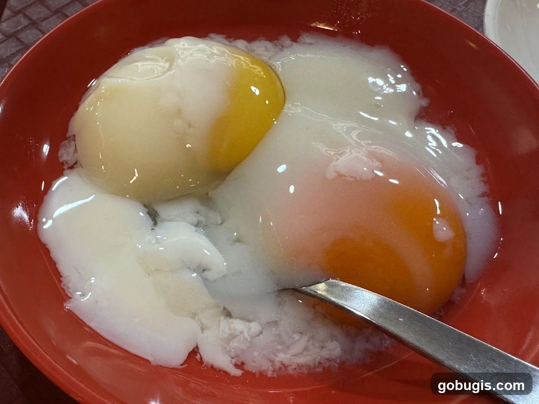 Soft-boiled eggs in a red bowl