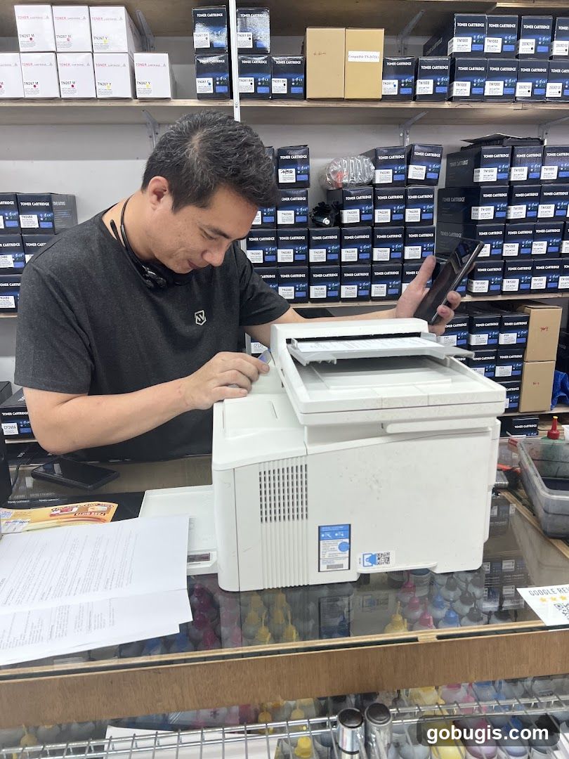 Man working with printer and phone