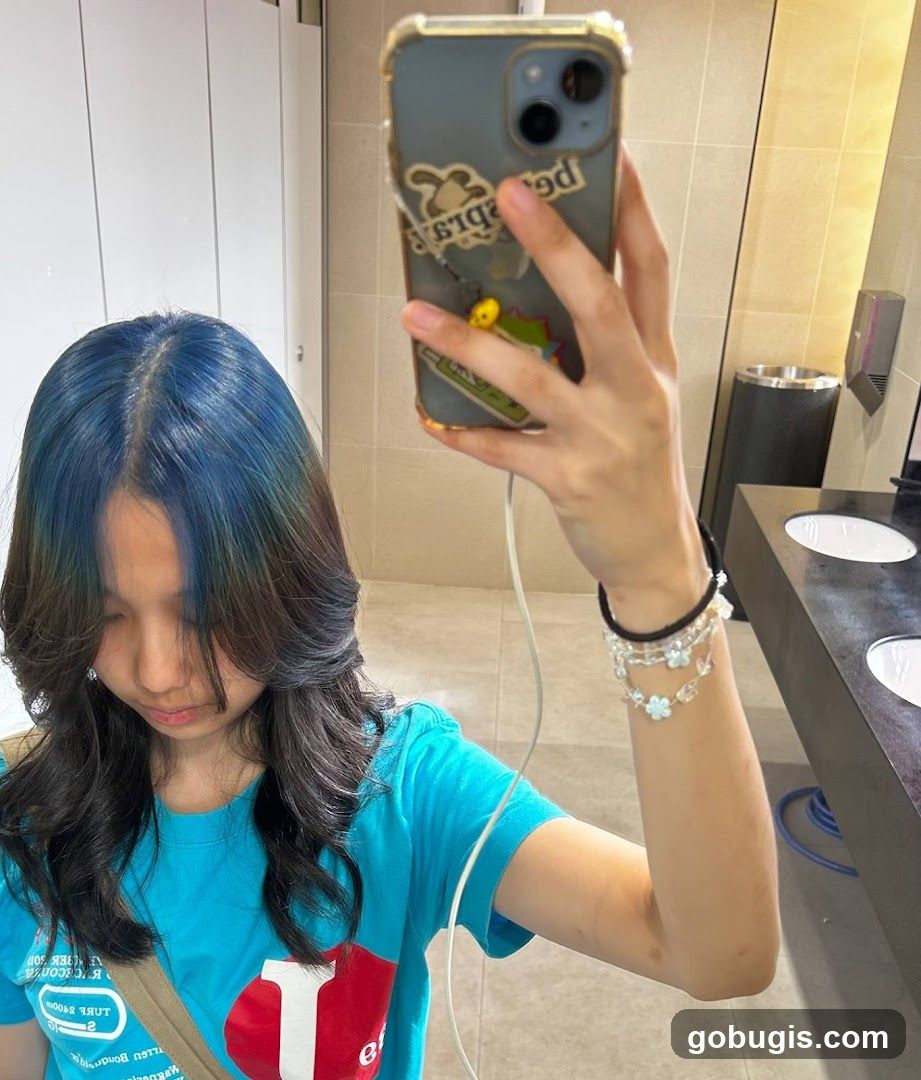 Woman taking a selfie in a restroom