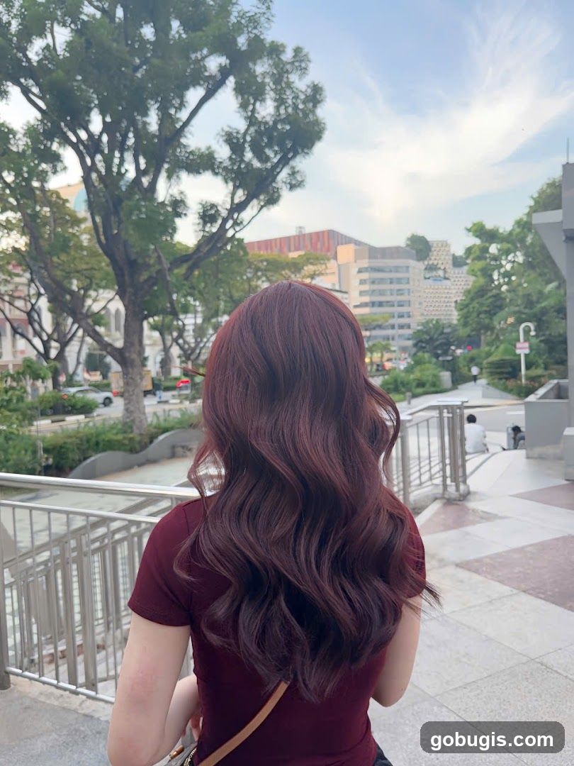 Woman with long wavy auburn hair
