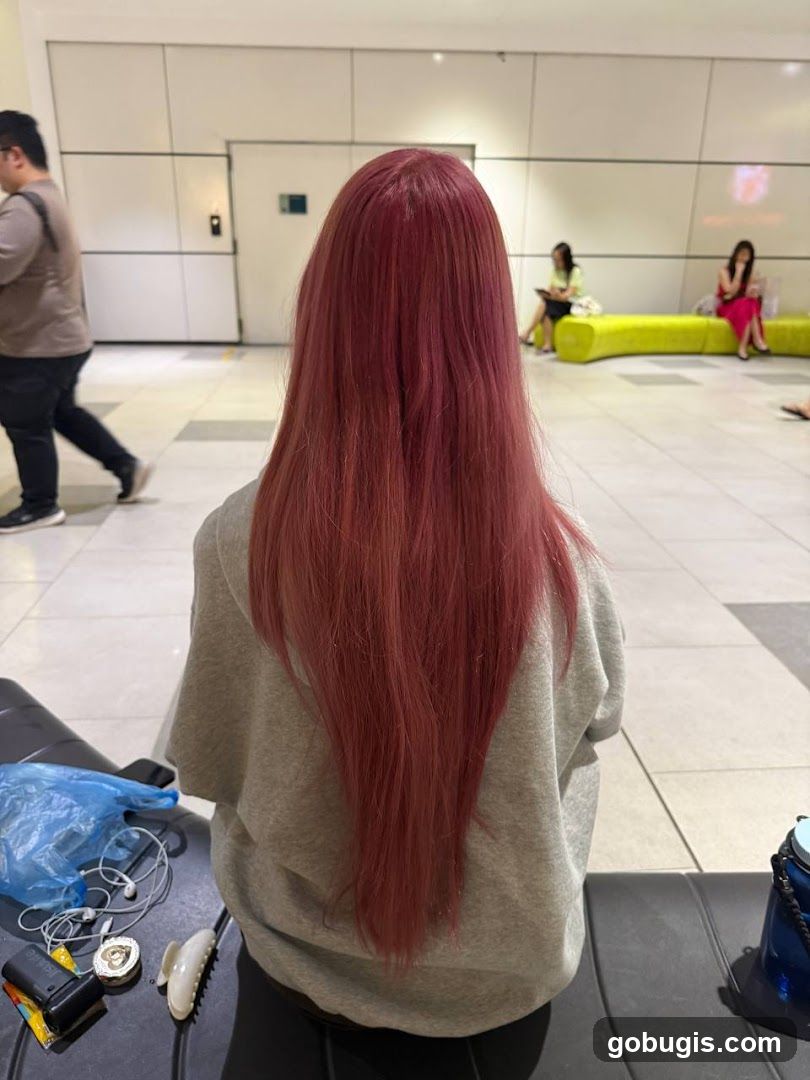 Woman with long red hair sitting