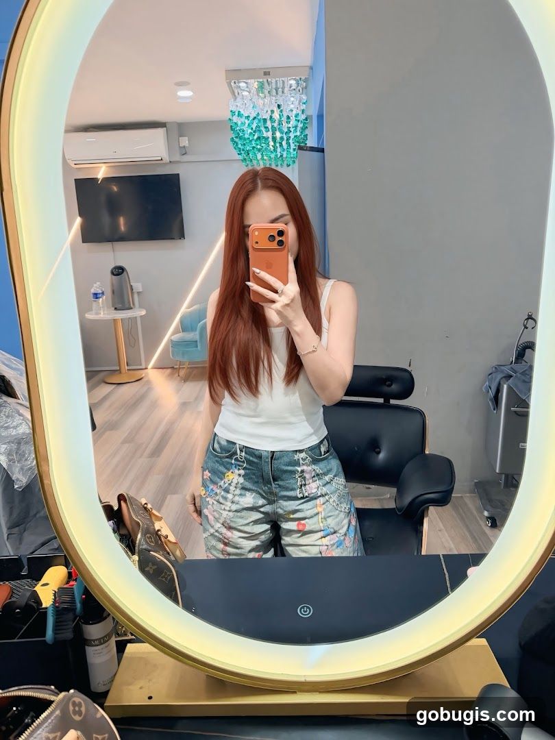 Woman Taking Mirror Selfie in Salon