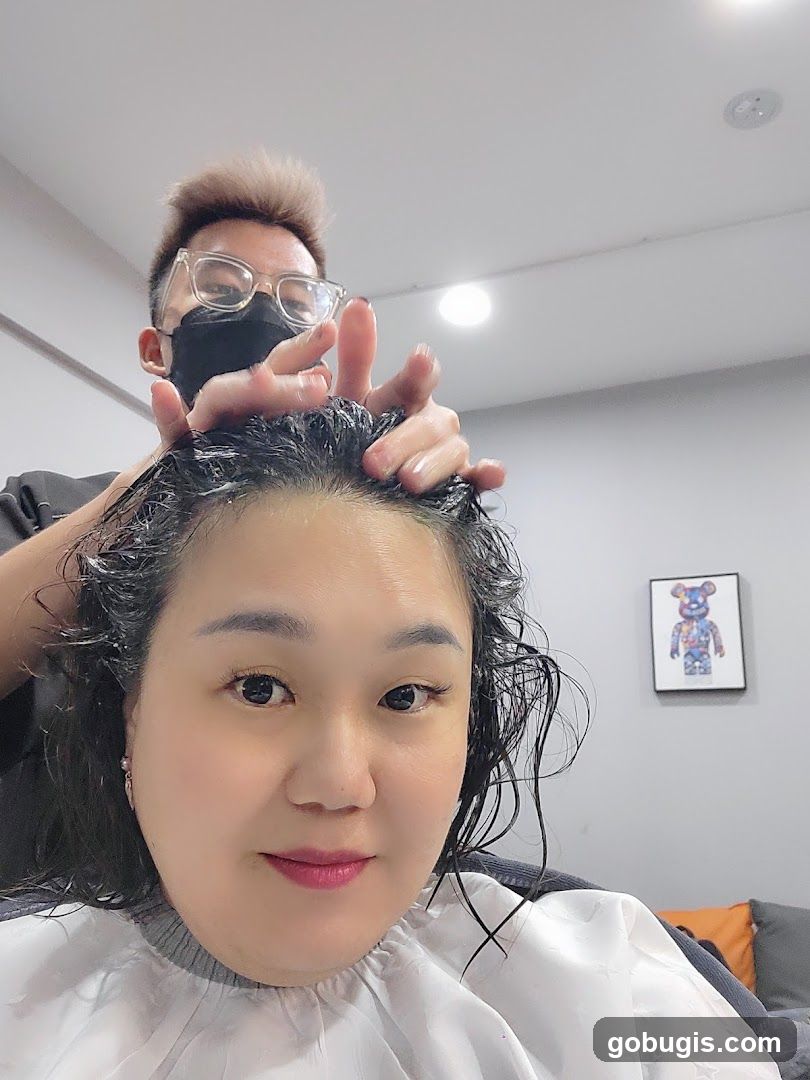 Hairdresser massaging client's scalp