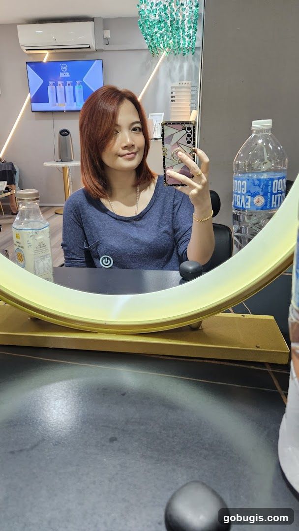 Woman taking a mirror selfie in a salon