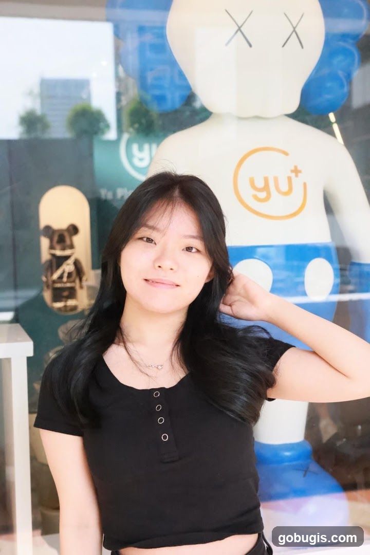 Woman Posing in Front of a Large Figure