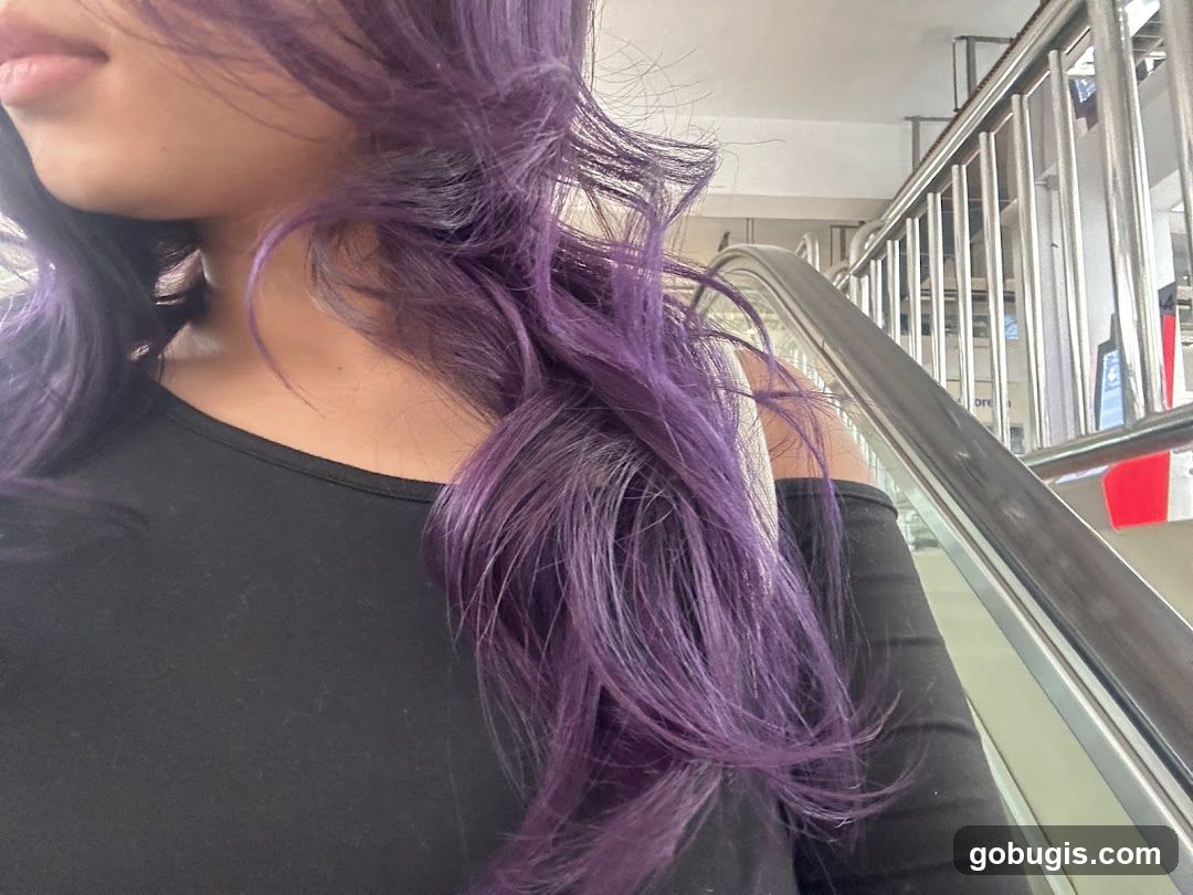 Woman with purple hair on escalator