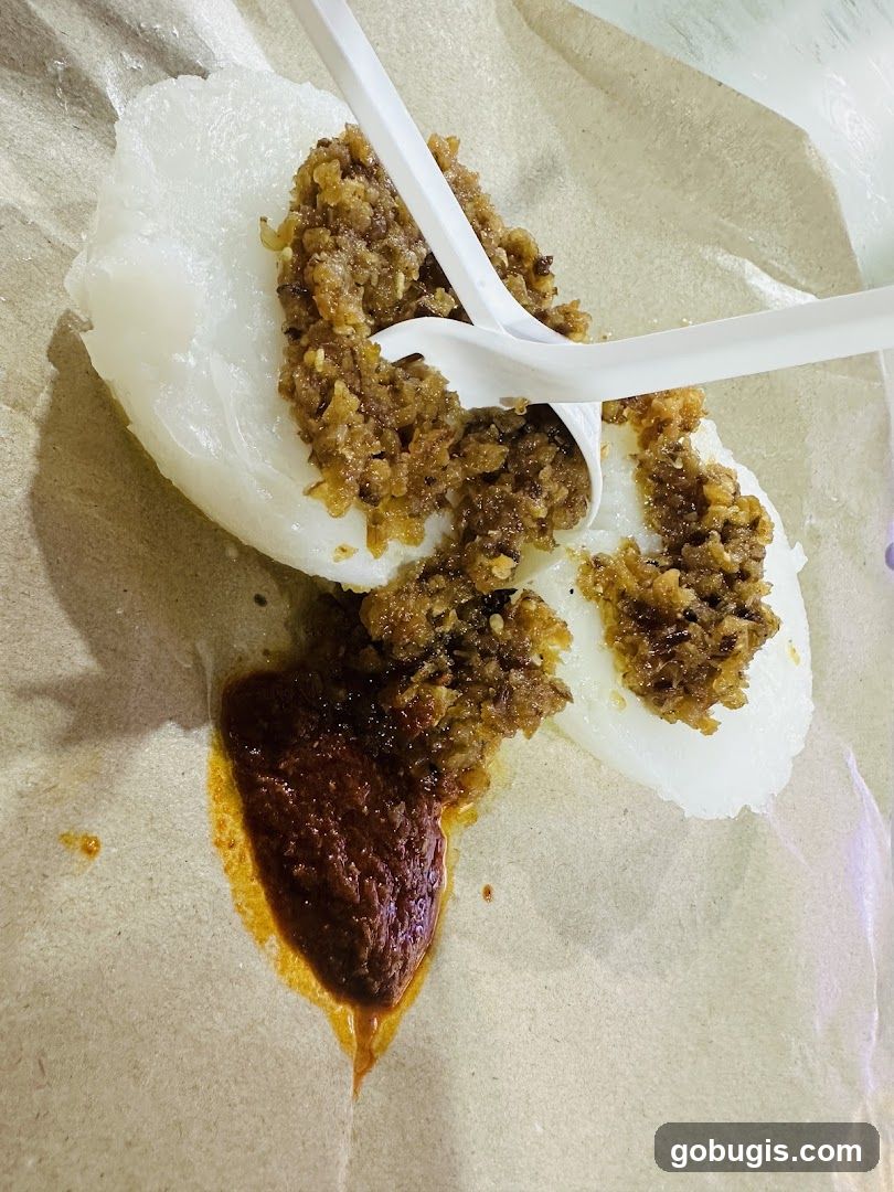 Rice cake with savory topping and chili sauce