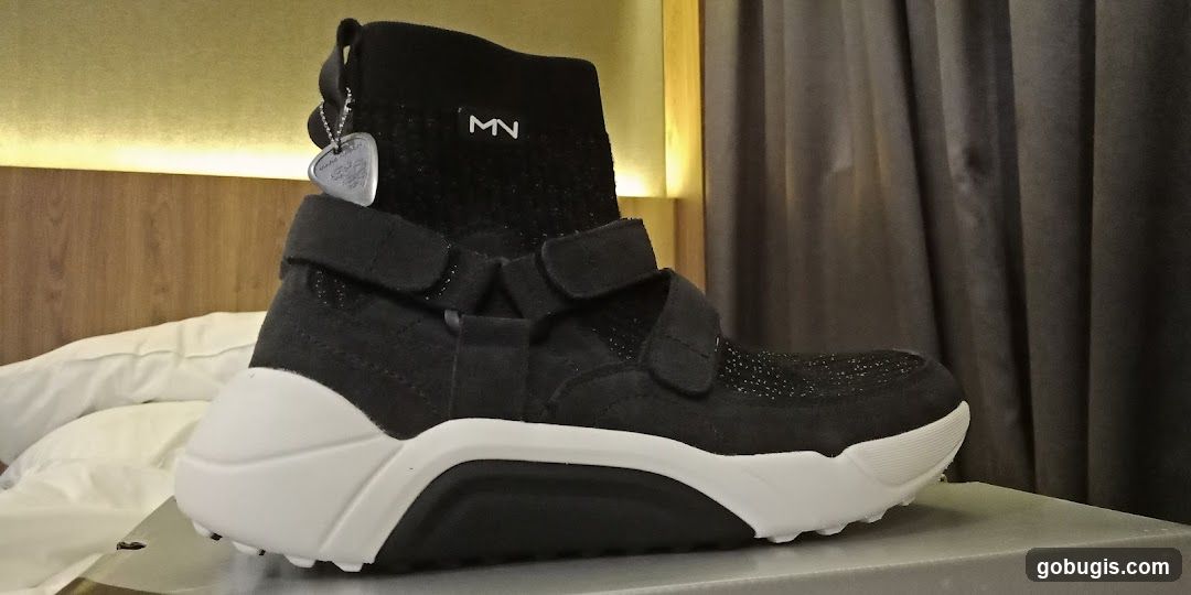 Black high-top sneaker with white sole