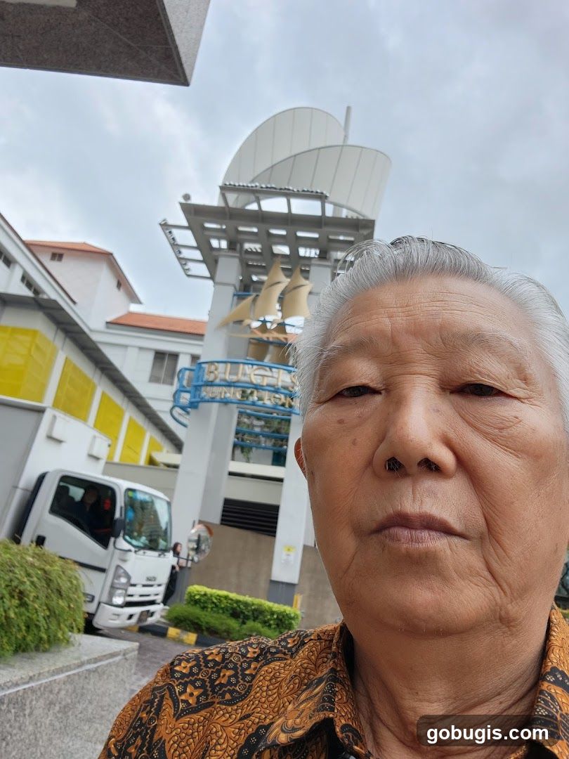 Elderly person in front of a building