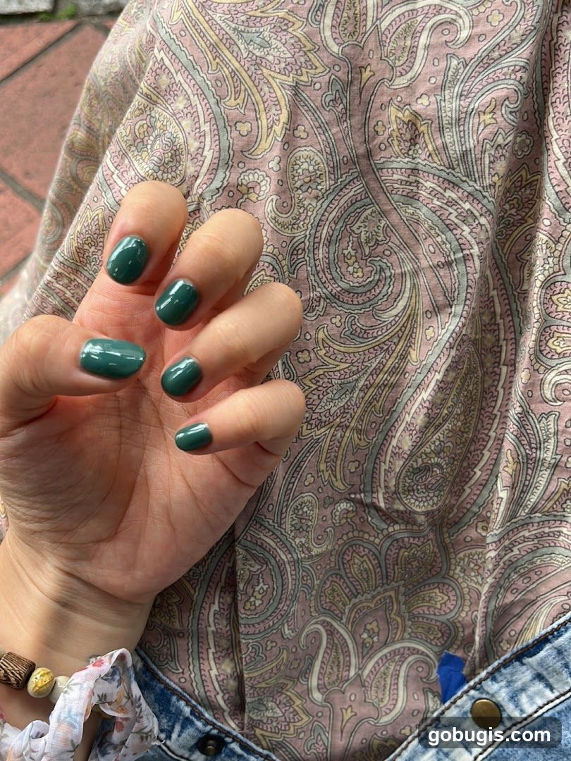 Woman's Hand with Green Nail Polish