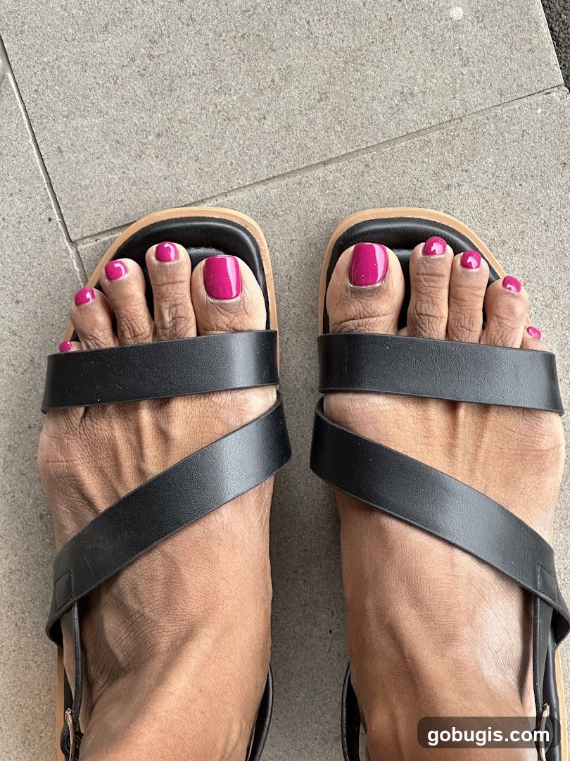 Feet with Pink Toenails and Black Sandals