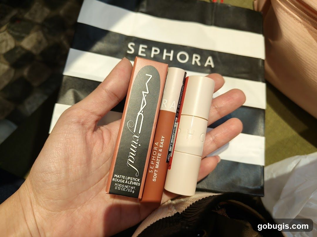 Hand holding makeup products with Sephora bag