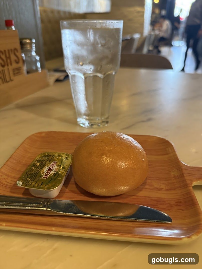 Bread roll with butter and water