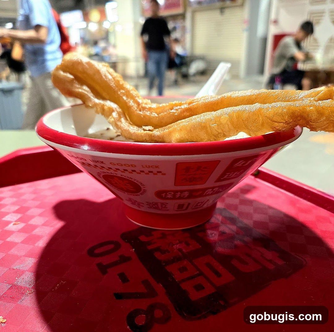 Bowl of food with fried dough sticks