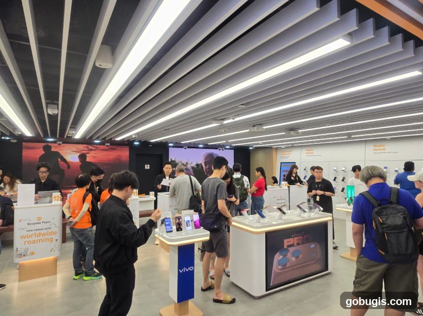 Customers browsing mobile phones in a store