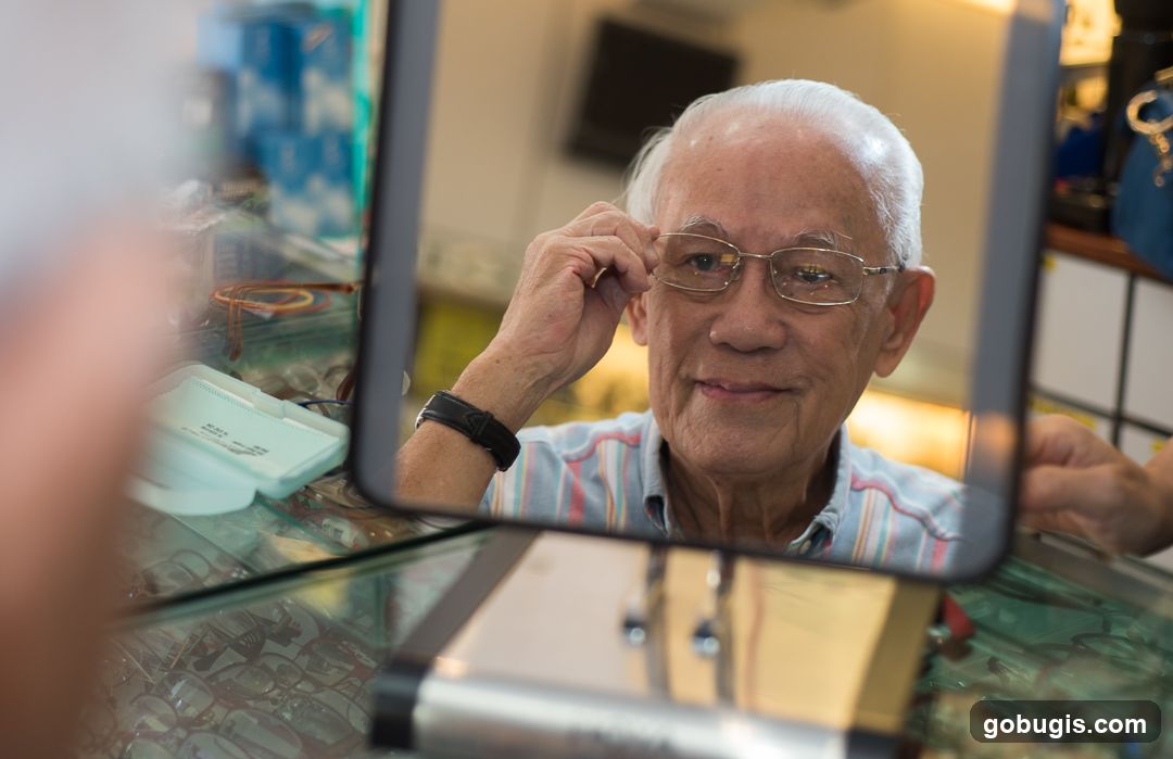 Elderly man trying on glasses