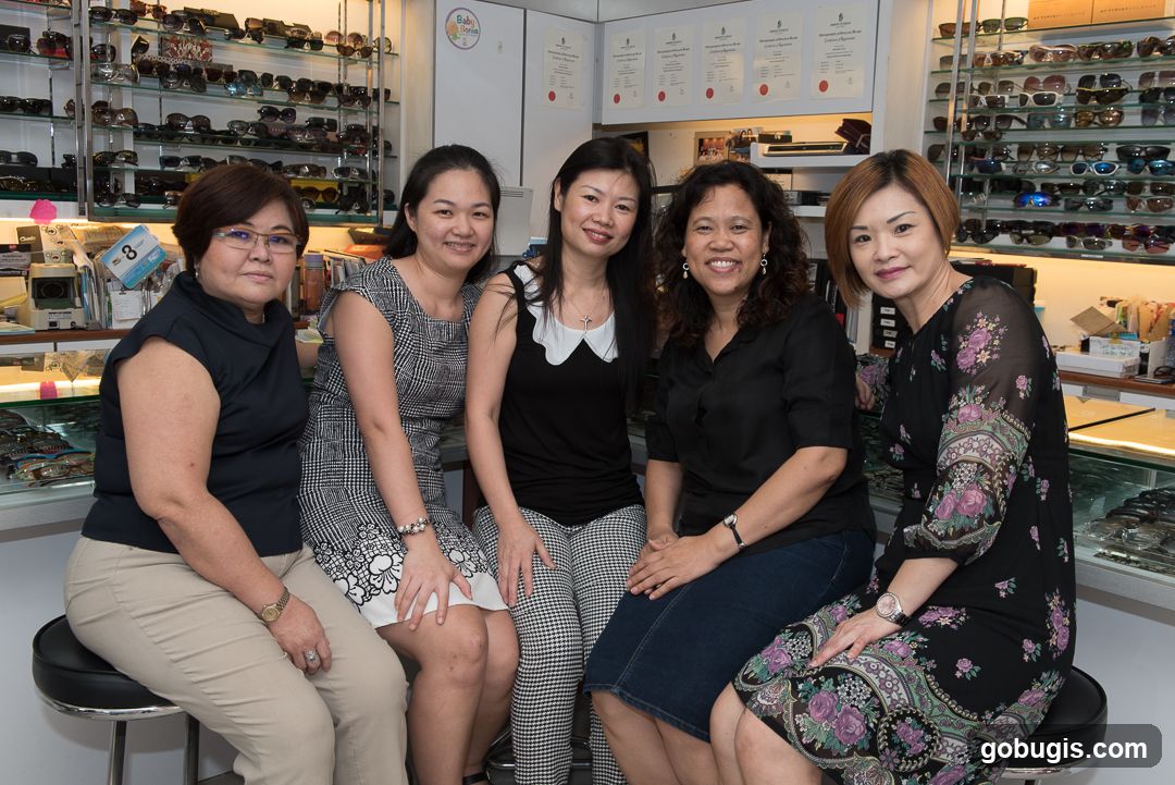 Five women posing in an optical shop
