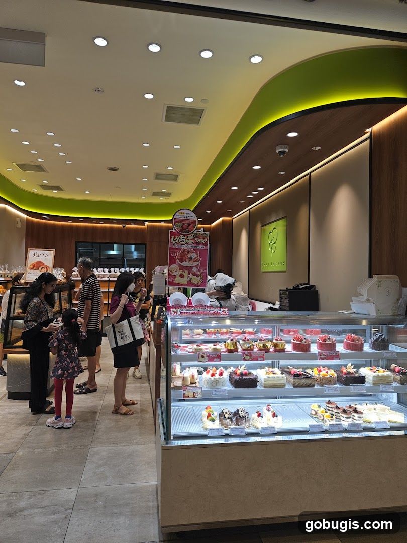 Interior of a bakery with display cases full of cakes and pastries.