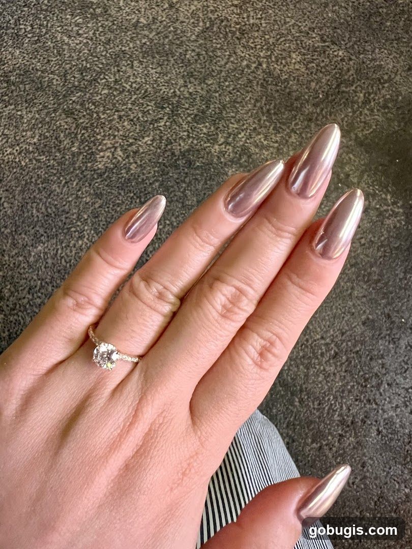 Hand with metallic nails and ring
