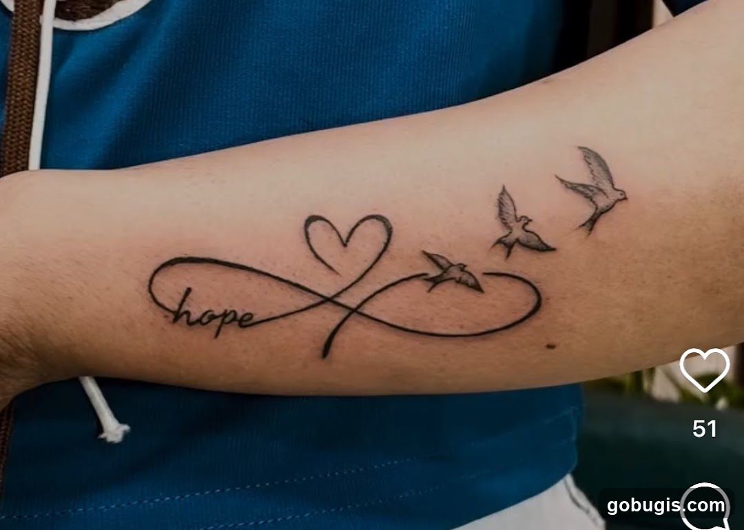 Infinity symbol tattoo with birds and heart